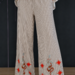 Trousers featuring embroidery, striped pattern.